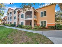 Two-story condo building with balconies and landscaping at 4140 Central Sarasota Pkwy # 1233, Sarasota, FL 34238