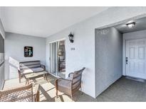 Relaxing screened porch with wicker furniture, perfect for outdoor enjoyment at 6713 Stone River Rd # 205, Bradenton, FL 34203