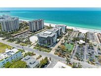 Aerial view highlighting condo's beach proximity and surrounding area at 1102 Benjamin Franklin Dr # 407, Sarasota, FL 34236