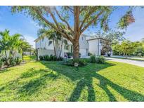Attractive curb appeal with lush lawn and large tree at 2586 Prospect St, Sarasota, FL 34239