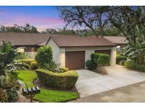 Two-car garage and well-manicured landscaping at dusk at 2917 Park Lake Dr # 2917, Bradenton, FL 34209