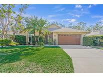 Single-story house with a brown garage door and well-manicured lawn at 3614 E 62Nd Ave, Bradenton, FL 34203