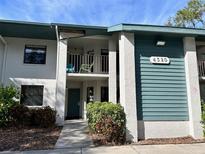 Two-story condo building with teal exterior and balconies at 4320 47Th W Ave # 203, Bradenton, FL 34210