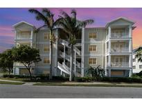 Three-story building with light-colored exterior, balconies, and palm trees at 7840 34Th W Ave # 103, Bradenton, FL 34209