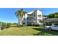 Exterior of two-story condo building with lush landscaping and parking at 8755 Olde Hickory Ave # 7101, Sarasota, FL 34238