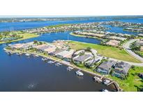 Aerial view of waterfront home with private dock and boat lift in a luxury community at 1014 Overlook Ct, Bradenton, FL 34208