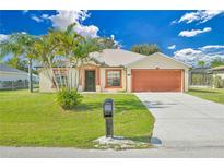 Single-story home with attached garage and landscaped lawn at 2073 Damascus Ln, Punta Gorda, FL 33983