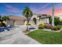 Attractive single-Gathering home with three-car garage, manicured lawn, and palm trees at 4211 Palacio Dr, Sarasota, FL 34238
