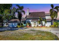 Charming white house with a spacious driveway and landscaping at 7104 9Th Avenue Nw Dr, Bradenton, FL 34209