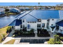 Aerial view showcasing the property's waterfront location and blue roof at 972 Sandpiper Cir # 972, Bradenton, FL 34209