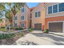Exterior view of condo building with attached garage and landscaping at 4106 Central Sarasota Pkwy # 1026, Sarasota, FL 34238