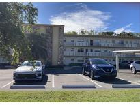 Two-story condo building with parking and landscaping at 4480 Ironwood Cir # 218A, Bradenton, FL 34209