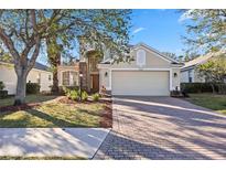 Two-story house with a brick driveway and landscaped lawn at 6364 Golden Eye Gln, Lakewood Ranch, FL 34202