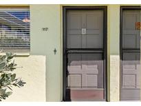 Exterior condo entrance with screen door at 6703 Midnight Pass Rd # 117, Sarasota, FL 34242