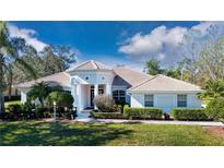 Beautiful one-story home with tile roof, lush landscaping, and a large driveway at 8532 Eagle Preserve Way, Sarasota, FL 34241