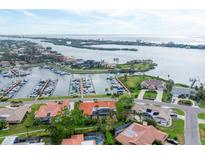 Breathtaking aerial view of waterfront property with private marina access and lush tropical landscaping at 312 Yacht Harbor Dr, Osprey, FL 34229