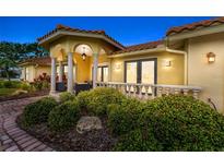 Stunning home featuring a beautifully landscaped front yard and a covered entryway with stone pillars at 312 Yacht Harbor Dr, Osprey, FL 34229