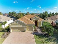 Stunning home with three-car garage, beautiful landscaping, and a well-manicured lawn at 13951 Wood Duck Cir, Lakewood Ranch, FL 34202