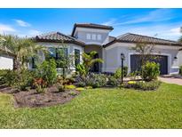 Beautiful single-story home with lush landscaping and a well-manicured lawn at 15603 Derna Ter, Bradenton, FL 34211