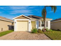 Charming single-story home features a yellow garage door, yellow front door, and a quaint front yard at 4107 11Th E St, Bradenton, FL 34208