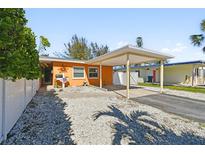 Cute orange house with carport and fenced yard at 426 62Nd St, Holmes Beach, FL 34217