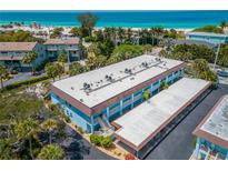 Coastal condo building featuring a covered parking area with beach access at 4307 Gulf Dr # 103, Holmes Beach, FL 34217