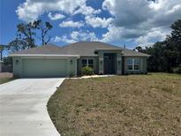 Charming single-story home featuring a two car garage and a well-manicured lawn at 5770 Englewood Rd., Venice, FL 34293