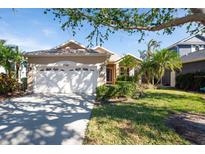 Single-story home with a two-car garage and well-maintained lawn at 11129 Sanctuary Dr, Bradenton, FL 34209