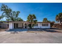 Front exterior of a single-story home with a carport and palm trees at 6536 Sabal Dr, Sarasota, FL 34242