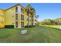 Building exterior showcasing yellow building and landscaping at 2060 Willow Hammock Cir # 304, Punta Gorda, FL 33983