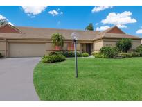 Tan one-story house with a lush green lawn and driveway at 3520 57Th Avenue W Cir # 10, Bradenton, FL 34210