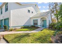 Charming attached home with teal double garage doors and lush landscaping at 6640 Pineview Ter # 6640, Bradenton, FL 34203