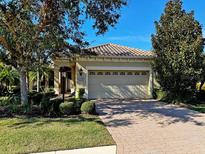 Single-story home with a two-car garage and landscaped front yard at 7130 Westhill Ct, Lakewood Ranch, FL 34202