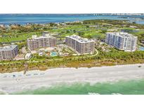 Luxury beachfront condominium complex with golf course, pool, beach access, and lush tropical landscape at 545 Sanctuary Dr # B406, Longboat Key, FL 34228