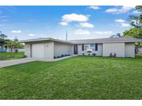 Charming single-story home featuring a well-maintained lawn and an attached garage in a residential neighborhood at 584 Beverly Rd, Venice, FL 34293