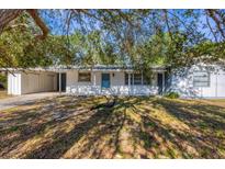 Ranch-style home with carport and mature landscaping at 795 40Th St, Sarasota, FL 34234