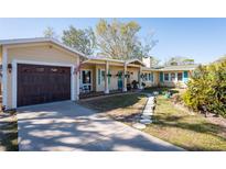 Charming ranch home with a large front yard, updated landscaping, and a two-car garage at 7402 Westmoreland Dr, Sarasota, FL 34243