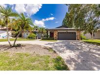 Single-story home with a two-car garage and landscaped yard at 7707 10Th Nw Ave, Bradenton, FL 34209