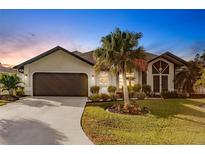 Attractive single-story home with a landscaped yard and a two-car garage at 301 Gold Tree, Punta Gorda, FL 33955