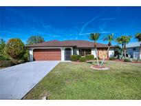 Single-story home with attached garage and palm trees at 36 Santarem Cir, Punta Gorda, FL 33983