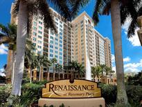 Luxury high-rise building with water view and palm trees at 750 N Tamiami Trl # 420, Sarasota, FL 34236