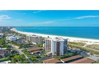 Aerial view of beachfront condo building with ocean and beach views at 101 Benjamin Franklin Dr # 54, Sarasota, FL 34236