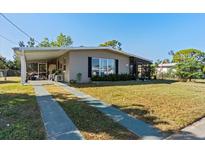 Ranch-style home with carport, screened porch, and spacious yard at 3197 Normandy Dr, Port Charlotte, FL 33952