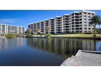 Condominium building with water access and a picturesque waterfront view at 5780 Midnight Pass Rd # 205, Sarasota, FL 34242