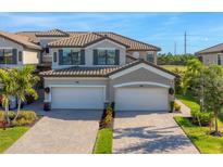 Two-story house with two-car garage, and nicely landscaped lawn at 6035 Worsham Ln # 104, Lakewood Ranch, FL 34211