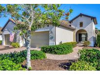 Charming single-story home with a welcoming front entrance and landscaped yard at 11265 Mc Dermott Ct, Englewood, FL 34223