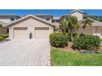 Attractive two-story townhome with a two-car garage and landscaped front yard at 1720 Starling Dr # 103, Sarasota, FL 34231