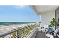 This home features a balcony with stunning views of the white sand beach and ocean at 2105 Gulf Of Mexico Dr # 3303, Longboat Key, FL 34228