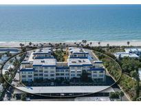Aerial view of beachfront condo building with ocean and beach views at 3806 Gulf Of Mexico Dr # C-312, Longboat Key, FL 34228