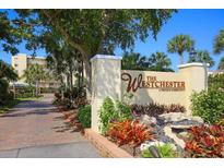 Westchester private community entrance with lush landscaping, decorative rocks, and elegant signage at 4825 Gulf Of Mexico Dr # 303, Longboat Key, FL 34228